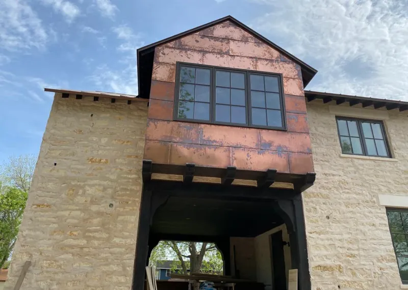 Copper metal panel facade on a stone building for Roof Repair in St. Augustine