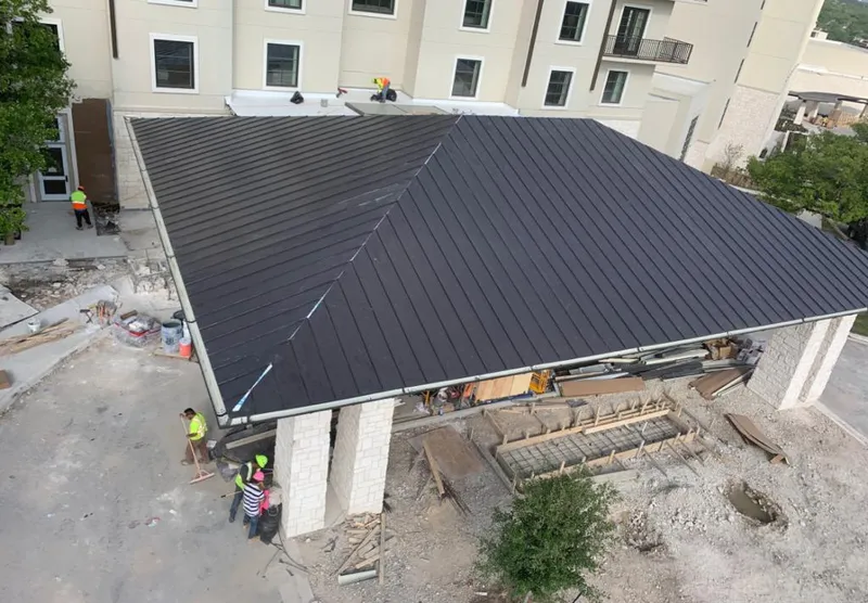 Metal roofing installation team working on a commercial building in St. Augustine